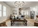 Bright living room features hardwood floors, stylish decor, and access to the staircase and kitchen at 13018 Deerstyne Green St, Carmel, IN 46032