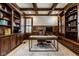Executive office featuring custom built-in shelving, rich wood paneling, and coffered ceilings at 13018 Deerstyne Green St, Carmel, IN 46032