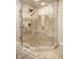 Stunning glass enclosed shower with tile surround and built in bench at 13018 Deerstyne Green St, Carmel, IN 46032