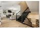 Elegant staircase with wrought iron railings leading to the living area, featuring hardwood floors and built-in shelving at 13018 Deerstyne Green St, Carmel, IN 46032