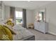 Stylized bedroom featuring large window, a full length mirror, dresser and gray carpets at 16906 Sandhurst Pl, Westfield, IN 46074