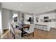 Bright kitchen and dining area with white cabinets, a center island, and a dining table with seating for six at 16906 Sandhurst Pl, Westfield, IN 46074