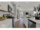 Modern kitchen featuring stainless steel appliances, white cabinetry, and a view into the living room at 16906 Sandhurst Pl, Westfield, IN 46074