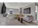 This living room has cozy seating, neutral tones and art on the wall at 16906 Sandhurst Pl, Westfield, IN 46074