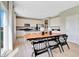 Bright dining area and open kitchen featuring modern appliances and an island with bar seating at 16959 Sandhurst Pl, Westfield, IN 46074