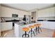 Modern kitchen boasts stainless steel appliances, sleek black countertops, and stylish seating at the island at 16959 Sandhurst Pl, Westfield, IN 46074