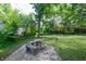 Backyard featuring a well-maintained lawn, a patio, and lush greenery at 1740 Haynes Ave, Indianapolis, IN 46240