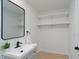 Updated bathroom with floating shelves, stylish mirror, and modern fixtures at 1740 Haynes Ave, Indianapolis, IN 46240