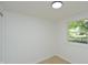 Well-lit bedroom featuring light-colored walls, wood floors, and a bright window with a view of the outdoors at 1740 Haynes Ave, Indianapolis, IN 46240