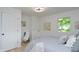 Bright bedroom with neutral decor, light-colored wood floors, and a large window for natural light at 1740 Haynes Ave, Indianapolis, IN 46240