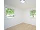 Bright bedroom with two windows and light wood flooring offering a serene living space at 1740 Haynes Ave, Indianapolis, IN 46240