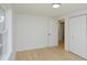 Bedroom with doorway, closet, light-colored walls, wood floors, and bright window with a view of the outdoors at 1740 Haynes Ave, Indianapolis, IN 46240