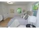 Bright bedroom with neutral decor, light-colored wood floors, and a large window for natural light at 1740 Haynes Ave, Indianapolis, IN 46240