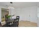 Bright dining room with modern lighting and a view into the adjacent living area at 1740 Haynes Ave, Indianapolis, IN 46240