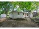 Charming ranch style home exterior with peach door, landscape with shed, and an American flag at 1740 Haynes Ave, Indianapolis, IN 46240