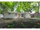 Inviting home with a peach-colored front door and newly landscaped yard with an American flag in the back at 1740 Haynes Ave, Indianapolis, IN 46240