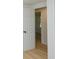 Hallway with view of bedroom featuring hardwood floors and white trim at 1740 Haynes Ave, Indianapolis, IN 46240