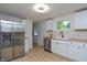 Updated kitchen boasts white cabinets, wood countertops, stainless steel appliances, and modern fixtures at 1740 Haynes Ave, Indianapolis, IN 46240