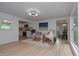 Bright, modern living room with light wood floors open to the kitchen with white cabinets at 1740 Haynes Ave, Indianapolis, IN 46240