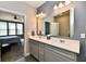 Gray bathroom featuring a double sink vanity, large mirror, and modern lighting at 2186 Chick Evans Way, Westfield, IN 46074