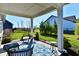 Inviting covered patio with comfortable seating and a view of the well-maintained lawn at 2186 Chick Evans Way, Westfield, IN 46074
