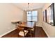 Bright dining room with modern chandelier, wood table, and dark hardwood floors at 2186 Chick Evans Way, Westfield, IN 46074