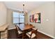 Bright dining room featuring modern chandelier, wood table, and wall art at 2186 Chick Evans Way, Westfield, IN 46074