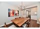 Dining room with wood table and chairs under modern light fixture at 2186 Chick Evans Way, Westfield, IN 46074