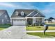 Charming single-Gathering home featuring a gray roof, and a pristine two-car garage at 2186 Chick Evans Way, Westfield, IN 46074