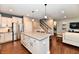 Open concept kitchen with an island including seating with hardwood floors at 2186 Chick Evans Way, Westfield, IN 46074