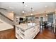 Open kitchen flows into living and dining areas with hardwood floors throughout at 2186 Chick Evans Way, Westfield, IN 46074