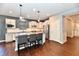 Open kitchen featuring stainless appliances, island with seating and hardwood floors at 2186 Chick Evans Way, Westfield, IN 46074