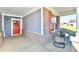 Inviting front porch with stylish seating, brick accents, and a welcoming red door with wreath at 2186 Chick Evans Way, Westfield, IN 46074