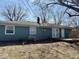 View of the exterior with a small wood patio in a peaceful backyard at 2308 W Surrey Dr, Muncie, IN 47304