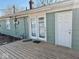 Exterior view of the backyard showing back door and wooden deck at 2308 W Surrey Dr, Muncie, IN 47304