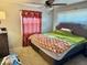 Comfortable bedroom with plush bedding, stylish curtains, and modern ceiling fan at 2308 W Surrey Dr, Muncie, IN 47304