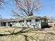 Charming ranch-style home featuring a cozy facade, attached garage, and well-maintained lawn at 2308 W Surrey Dr, Muncie, IN 47304
