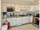 Kitchen has white cabinets, tile flooring, and stainless steel stove at 2308 W Surrey Dr, Muncie, IN 47304
