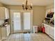 Kitchen has white cabinets, double doors with window panes, and tile flooring at 2308 W Surrey Dr, Muncie, IN 47304