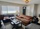 Cozy living room featuring a light fixture, front door, and lots of windows at 2308 W Surrey Dr, Muncie, IN 47304
