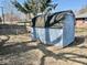 Backyard view of storage shed with chain link fence and mature tree at 2308 W Surrey Dr, Muncie, IN 47304