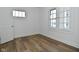 Inviting bedroom with hardwood floors and ample natural light from two windows, creating a cozy atmosphere at 2528 S New Jersey St, Indianapolis, IN 46225