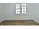 Bright bedroom featuring hardwood floors, a neutral color scheme, and large window for ample natural light at 2528 S New Jersey St, Indianapolis, IN 46225