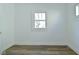 Bright bedroom showcasing a window for ample natural light, light walls, and wood floors for a clean design at 2528 S New Jersey St, Indianapolis, IN 46225