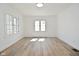 Sunlit bedroom with light colored walls and modern floors, featuring multiple windows at 2528 S New Jersey St, Indianapolis, IN 46225