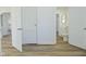 Hallway with hardwood floors connecting to bathroom featuring a toilet and sink at 2528 S New Jersey St, Indianapolis, IN 46225