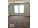 Bright bedroom featuring neutral paint, plush carpet, and a double-hung window at 302 S Randolph St, Indianapolis, IN 46201