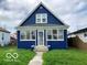 Charming blue two-story home featuring a welcoming front entrance and lush green lawn at 302 S Randolph St, Indianapolis, IN 46201
