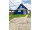 Exterior showcasing the blue finish with green grass and a sidewalk at 302 S Randolph St, Indianapolis, IN 46201