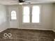 Bright living room featuring durable laminate flooring, updated fixtures, and ample natural light at 302 S Randolph St, Indianapolis, IN 46201